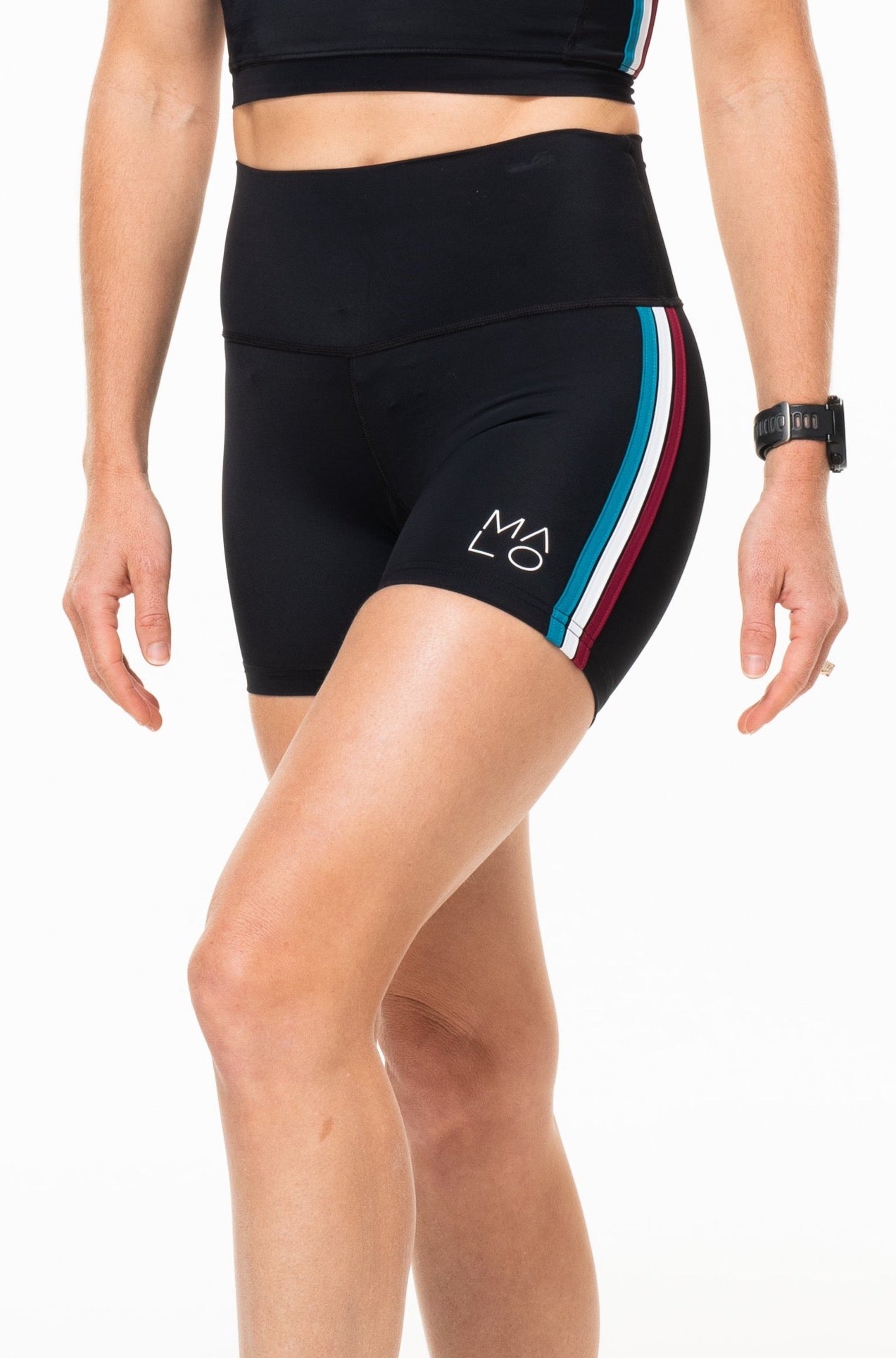 Left view Little Bit Longer Shorts. Women's black high-waisted workout shorts. Striped athleisure shorts.