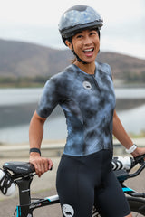 Model wearing women's Storm tri suit by her bike.