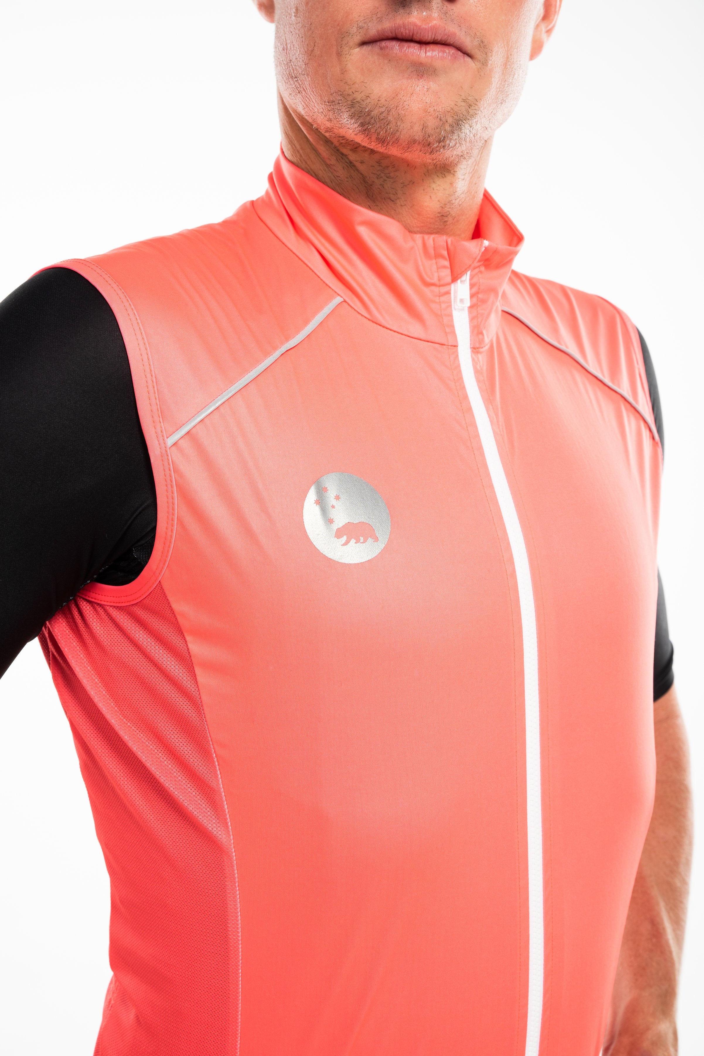 Close view men's neon gilet. Wind-stop fabric for warmth. Reflective bear logo for safety.
