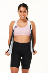 Model wearing unzipped  tri classics sleeveless top. Women's aerodynamic triathlon top with full front zipper.