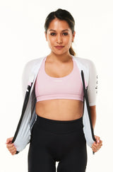 Model wearing unzipped Tri Classics Aero+ Sleeved Top. Women's tri top with full front zipper.
