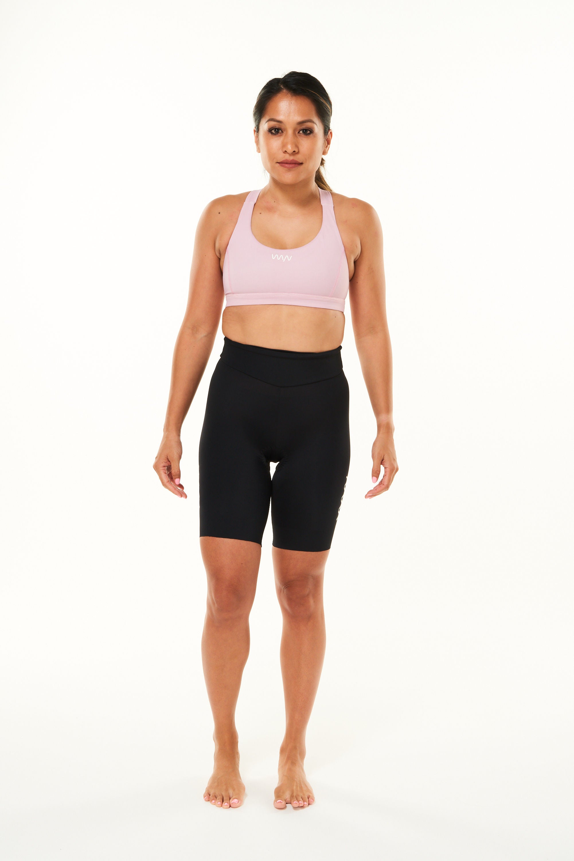 Model wearing women's Velocity Tri Shorts 7.5". Black aerodynamic triathlon shorts.