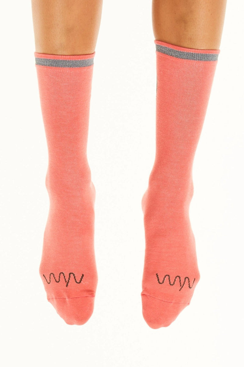 Front view Reflect Flagship Sock. Coral running/cycling socks with reflective strip on cuff.