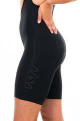 Left leg of women's Velocity 2.0 Cycling Bib Shorts. Women's black cycling shorts with WYN logo on thigh.