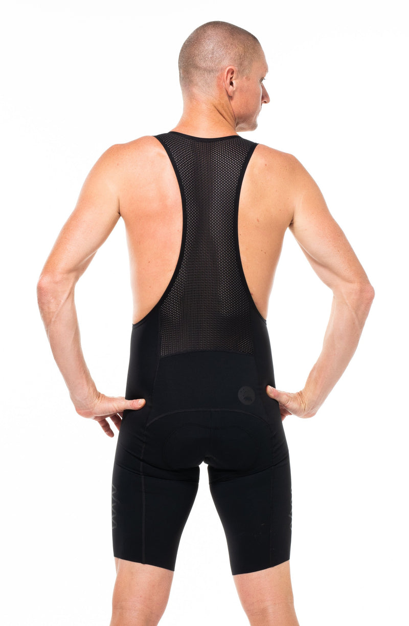 Back view of men's Velocity 2.0 Cycling Bib Shorts. Aerodynamic black cycling shorts with mesh back panel.