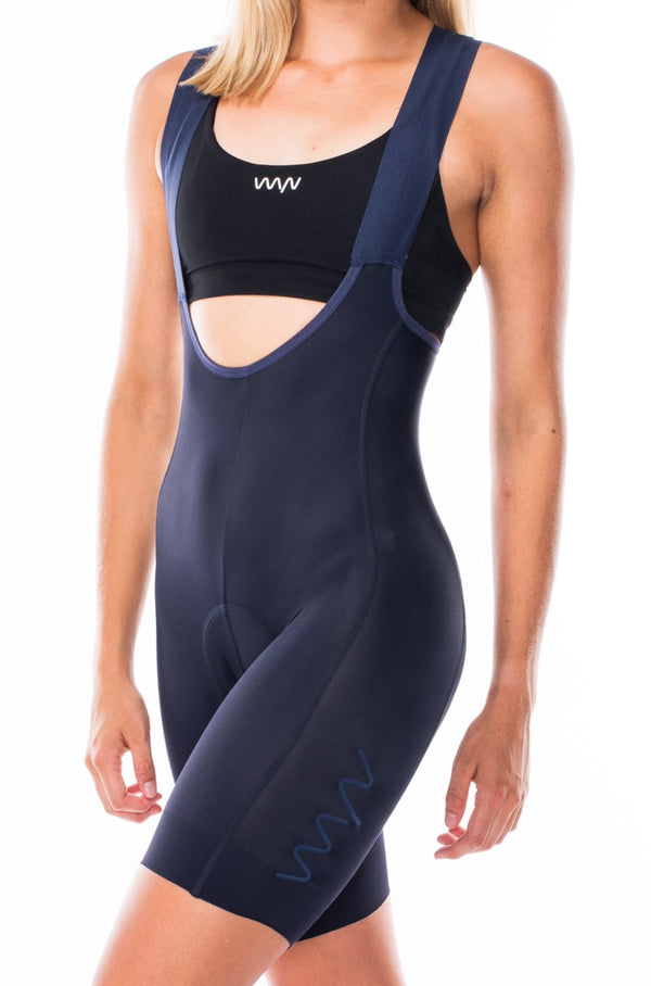 Women's Velocity 2.0 Cycling Bib Shorts. Navy bib shorts with blue WYN republic logo on thigh.