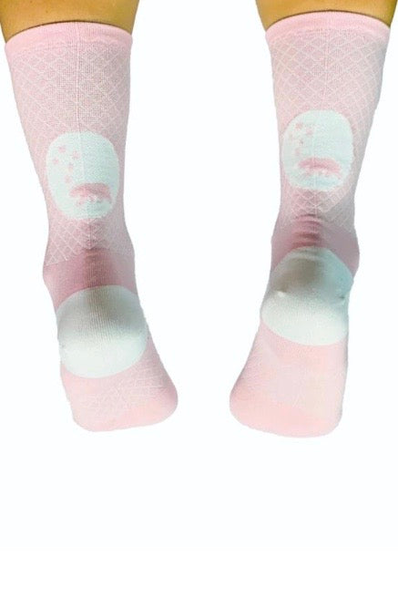 Back view WYN republic Carly Socks. Pink mid-calf running/cycling socks with white bear logo.