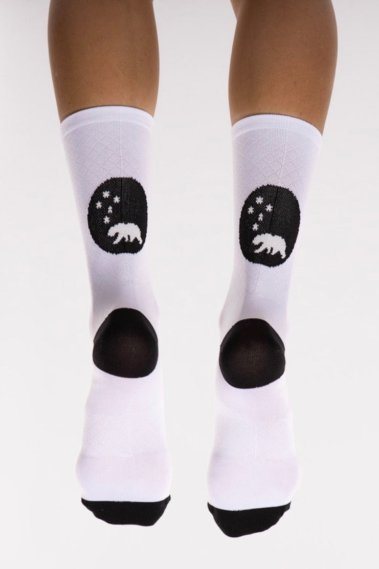 Back view WYN republic White Flagship Socks. White multi-sport socks with black bear logo.