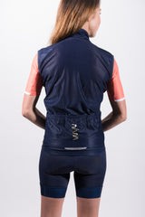 Back view women's gilet. Navy cycling vest with mesh panel and 3 storage pockets with reflective logo. 