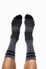 Legs in the air showing top of Gray and Black Flagship socks. Gray mid-calf socks with black stripes.