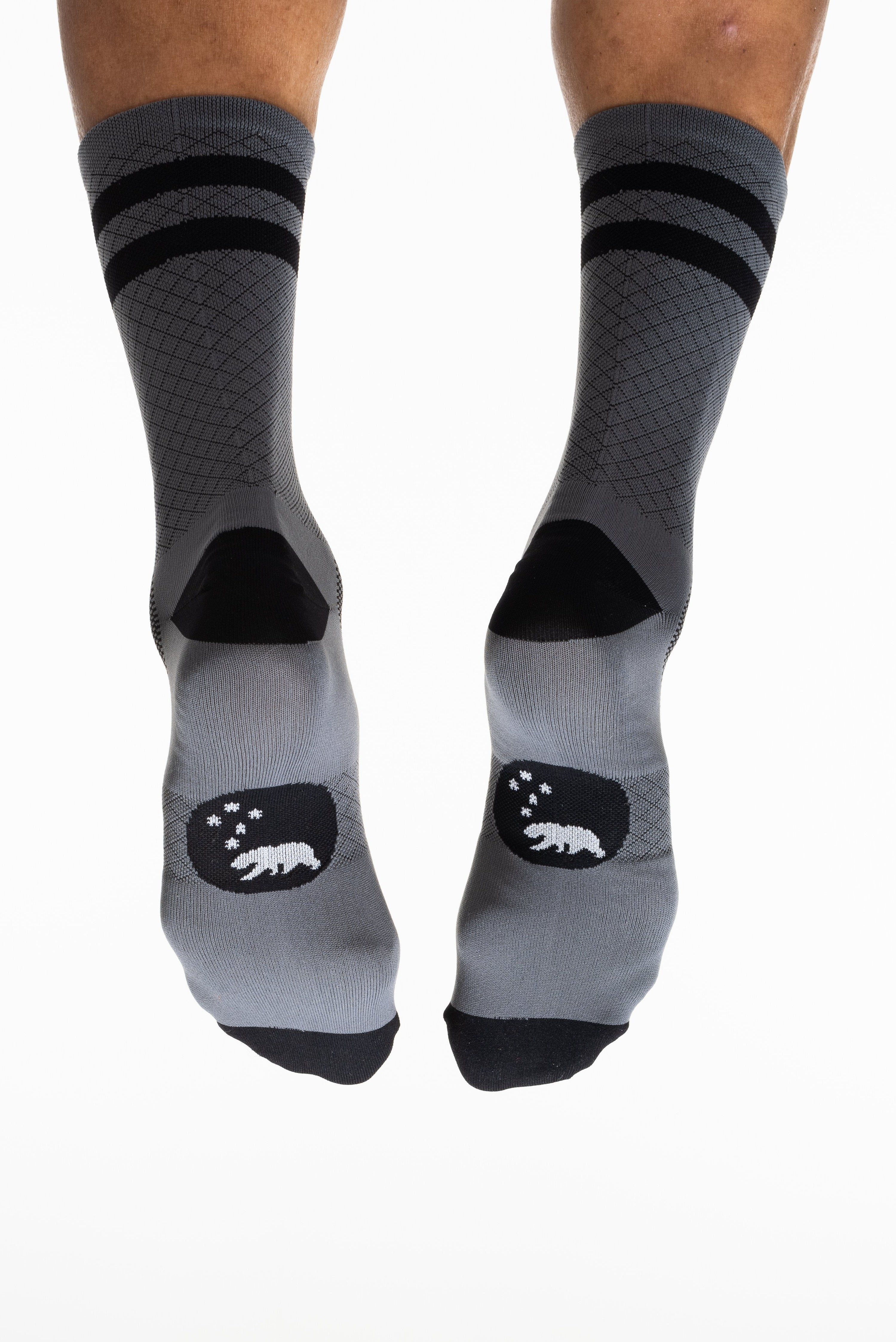 Back and bottom view of WYN Flagship Grey socks. Grey socks with black stripes on calf and bear logo on sole.