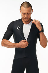 Model zipping men's Onyx Hex Racer Jersey. Black cycling jersey with flip-lock zipper.