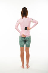 Model placing phone in back pocket of Carly Summer Long Sleeve Jersey. Cycling jersey with storage.