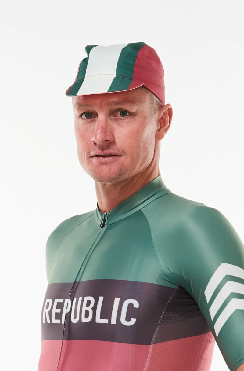 Model wearing Alliance cycling cap. Green and white strip center with red sides cycling hat.